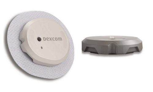 Close-up of Dexcom G7 sensor, one standing at an angle & one laying flat next to it